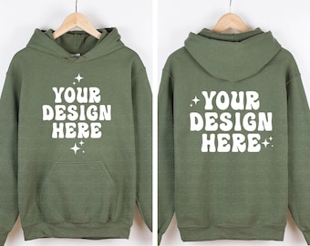 May include: An olive green hooded sweatshirt featuring the white text "YOUR DESIGN HERE" in a bold, wavy font on both the front and back. The design includes small white four-pointed star accents above and below the text on the front.