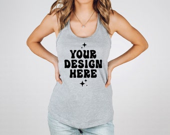 May include: A heather gray racerback tank top featuring the black text YOUR DESIGN HERE in a bold, wavy font, accented by four small four-pointed star icons positioned above and below the text, centered on the front of the garment.