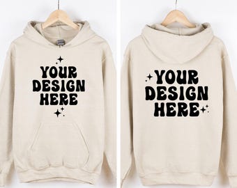 May include: A beige hooded sweatshirt featuring the black text YOUR DESIGN HERE in a bold, wavy font on the front and back. The design includes small four-pointed star accents above and below the text, with a front kangaroo pocket visible.