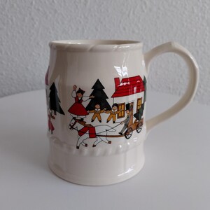 May include: A set of three ceramic mugs with a speckled, matte finish. The mugs are in shades of cream, light gray, and dark gray. Each mug has a simple, modern design and a rounded handle.