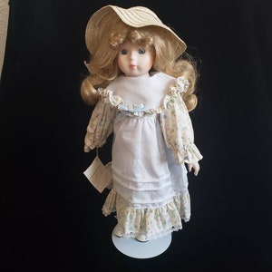 Little Luvables Blonde Porcelain Girls Doll with stand and label fully costumed 17 &quot; tall