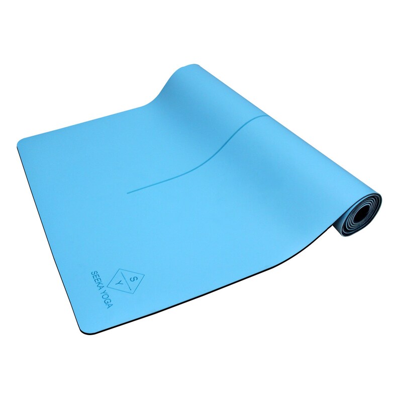 May include: A light blue yoga mat rolled up with a black border and a white line down the center. The mat has the text "SEEKA YOGA" and a logo with the letters "S" and "Y" in a diamond shape.