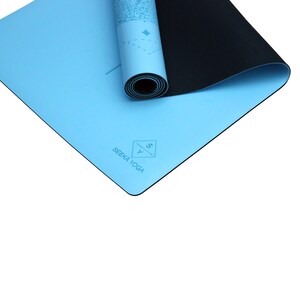 May include: A light blue yoga mat with a black underside. The mat is rolled up and has a logo that says "SEEKA YOGA" with a stylized "S" and "Y" in a diamond shape.