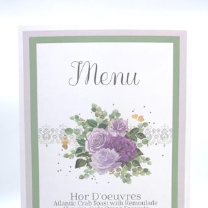 May include: A menu card with a floral design featuring purple roses and green foliage. The word "Menu" is written in elegant script at the top. The menu lists appetizers, sandwiches, desserts, and beverages.