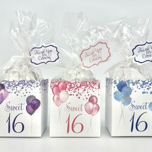 May include: Three favor boxes with a sweet 16 theme. Each box has a different color scheme: purple, pink, and blue. The boxes are decorated with confetti and balloons. Each box has a tag that says "Thank You for Coming".