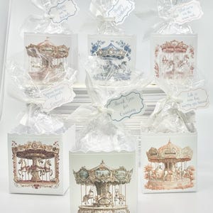 May include: A set of six favor boxes decorated with carousel horses and the text "Happy Birthday", "Happy to be your friends", "God we're on the same side", "Spring brings Carousels", "Thank you for coming", and "Life is one big merry-go-round".