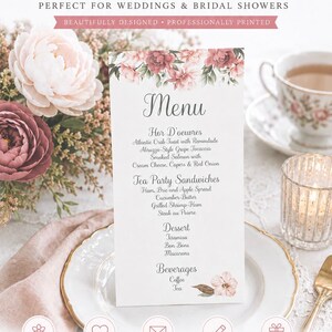 May include: A vertical white menu card featuring a floral illustration of pink and burgundy peonies at the top and a small flower at the bottom. The text lists sections for Hor D'oeuvres, Tea Party Sandwiches, Dessert, and Beverages.