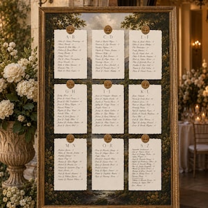 May include: A rectangular wedding seating chart displayed on a wooden easel, featuring a landscape painting background with nine white paper cards arranged in a grid. Each card lists guest names by alphabet, topped with a gold circular wax seal.