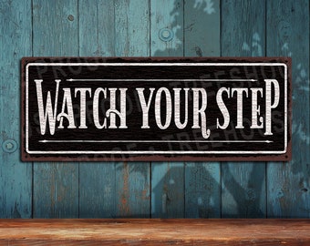 Watch Your Step • Black & White Rustic Looking Aluminum Sign • Color Imprint on Rustproof Aluminum • Customizable  • Made in USA • THC2655-A