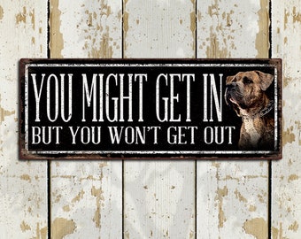 May include: Black and white metal sign with the text "You might get in but you won't get out". A brown and white dog is pictured on the right side of the sign.