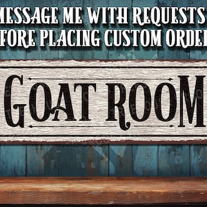 May include: A rustic white sign with black lettering that reads "GOAT ROOM". The sign has a distressed, vintage look and is perfect for a farmhouse or barn setting.