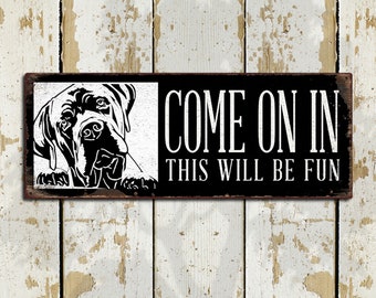 May include: Black and white sign with a dog's head peeking out from the left side. The sign reads "Come on in this will be fun".