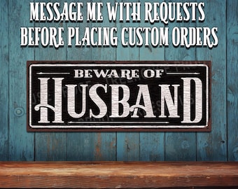 Beware Of Husband Metal Sign: • Black & White Rustic Looking Sign - Color Imprint on Rustproof Aluminum • Made in the USA - THC2934-A