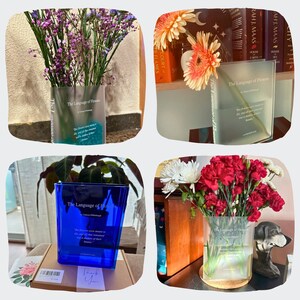 Acrylic book-shaped vase filled with vibrant flowers, placed on a modern bookshelf, perfect for home decor and gifting for events, birthdays, and housewarmings customer photo review