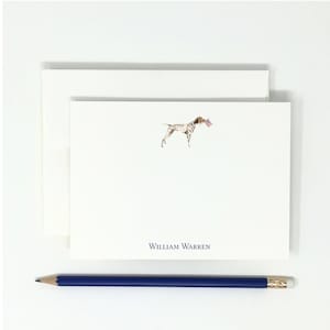 May include: A white card with a brown and white dog holding a small American flag in its mouth. The dog is standing on a white background. The text "WILLIAM WARREN" is printed in blue at the bottom of the card.