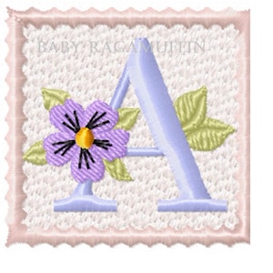 May include: A light blue letter A with a purple flower and green leaves on a white background with a pink scalloped border. The text "BABY RAGAMUFFIN" is at the top of the image.