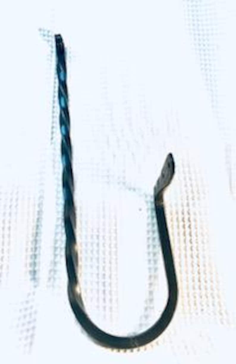 May include: Black metal hook with a twisted design. The hook is curved at the end and has a flat base.