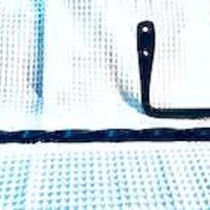 May include: Black metal towel rack with a twisted design. The rack has a hook on one end and a curved arm on the other end.