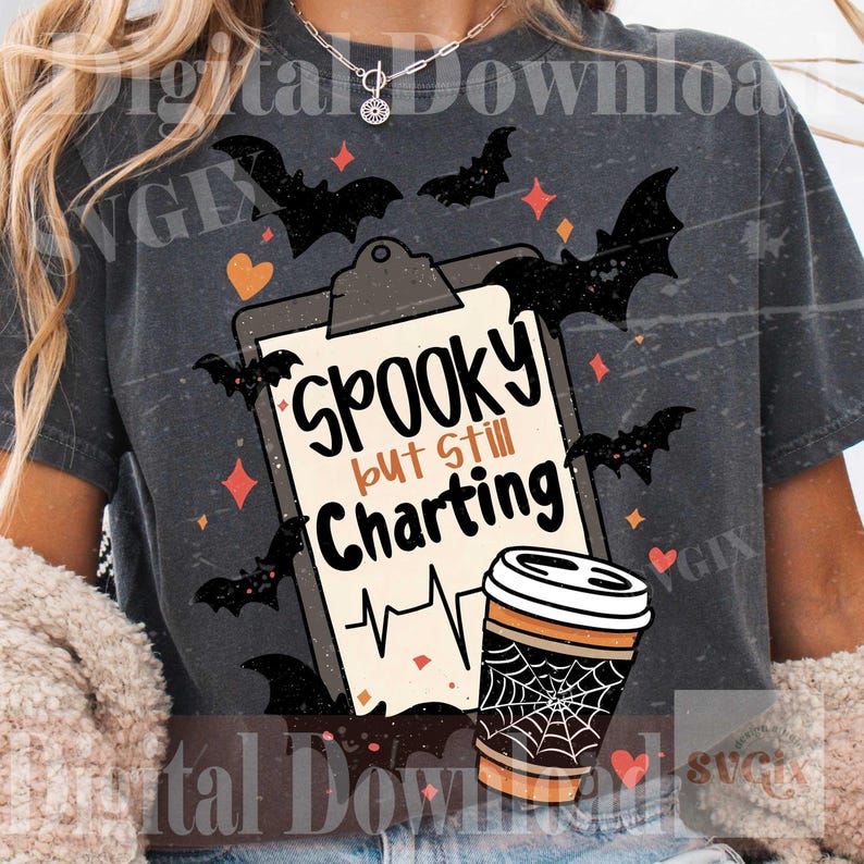 May include: A charcoal gray t-shirt featuring a graphic of a clipboard with the text Spooky but Still Charting, a heart rhythm line, a coffee cup with a spiderweb design, and black bats, orange hearts, and small diamond shapes.