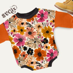 May include: A baby bodysuit with a floral pattern in shades of pink, orange, yellow, and black. The sleeves are solid orange, and the neckline is black. The design studio logo "svgix" is in the upper left corner.