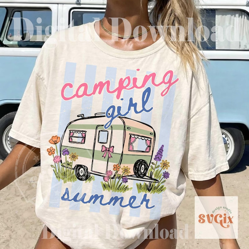 May include: Cream t-shirt featuring the words "camping girl summer" and a camper graphic with flowers. The text is pink and blue, set against a light blue striped backdrop.