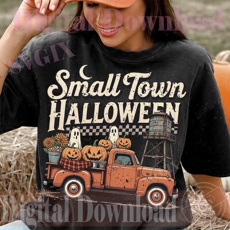May include: A black t-shirt featuring a graphic of an orange vintage pickup truck carrying pumpkins and two ghosts. The text reads Small Town HALLOWEEN. The design includes a water tower, a checkered pattern, and a crescent moon in a retro style.