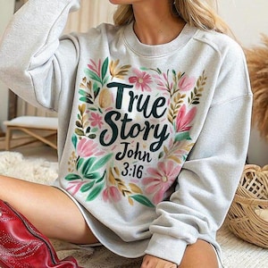 May include: Gray sweatshirt with a floral design and the text "True Story John 3:16".
