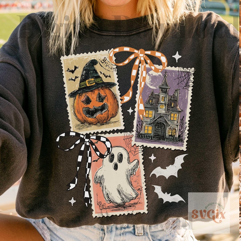 May include: A charcoal gray crewneck sweatshirt featuring three rectangular postage stamp-style graphics. The designs include a jack-o'-lantern in a witch hat, a haunted house, and a ghost, accented with orange and black checkered ribbons.