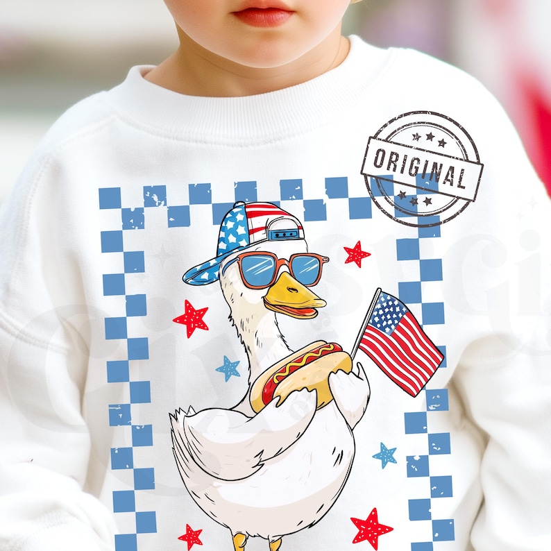 May include: White sweatshirt with a cartoon duck wearing sunglasses and a red, white, and blue baseball cap. The duck is holding a hot dog and a small American flag. The background is a blue and white checkered pattern with red stars.