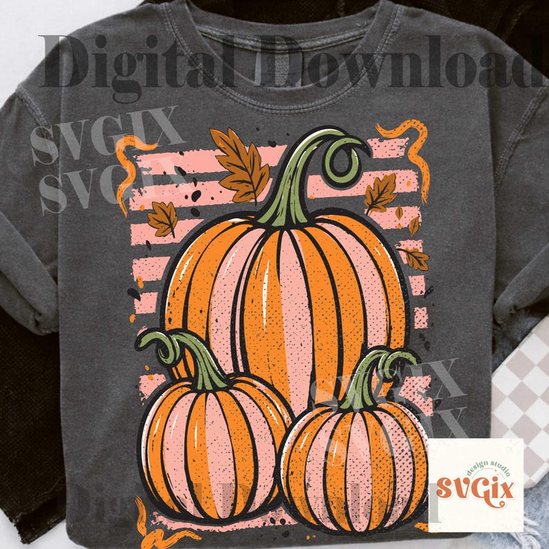 May include: Dark gray sweatshirt featuring a graphic of three pumpkins in shades of orange and pink, with green stems and autumn leaves. The design includes a pink striped background and the text "Digital Download" at the top.