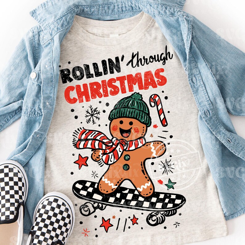 May include: A light grey t-shirt with the words "ROLLIN' through CHRISTMAS" in black and red. The shirt features a gingerbread man wearing a green hat and scarf, riding a skateboard. A pair of black and white checkered slip-on shoes are in the foreground.