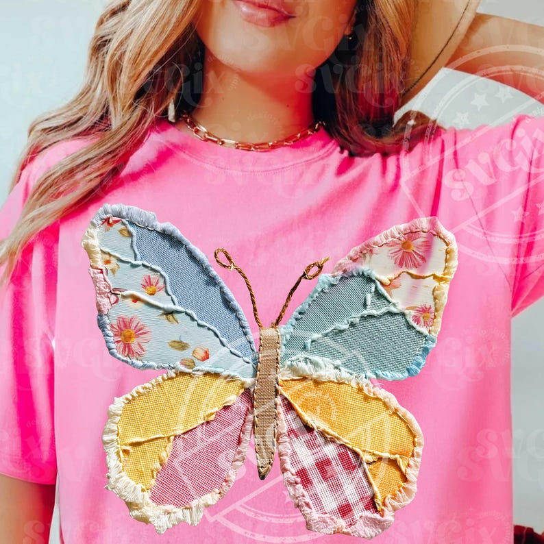 May include: A bright pink t-shirt featuring a colorful patchwork butterfly design. The butterfly has wings in shades of blue, yellow, pink, and red, with floral and plaid patterns. The shirt is a solid pink color.