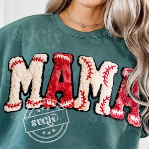 May include: Teal sweatshirt with the word "MAMA" in a baseball-themed design. The letters are a combination of red and off-white, with red stitching details. The design includes a logo that says "svgix design studio".
