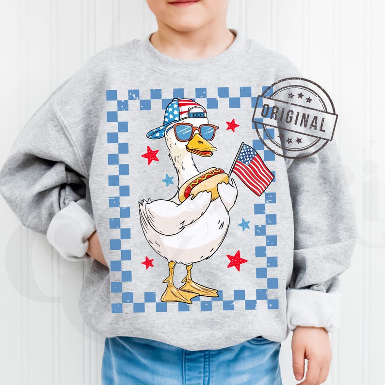 May include: A gray sweatshirt with a white, blue, and red checkered background. A cartoon duck wearing a red, white, and blue baseball cap, sunglasses, and holding a hot dog and an American flag. The text "ORIGINAL" is in a red circle with white stars.