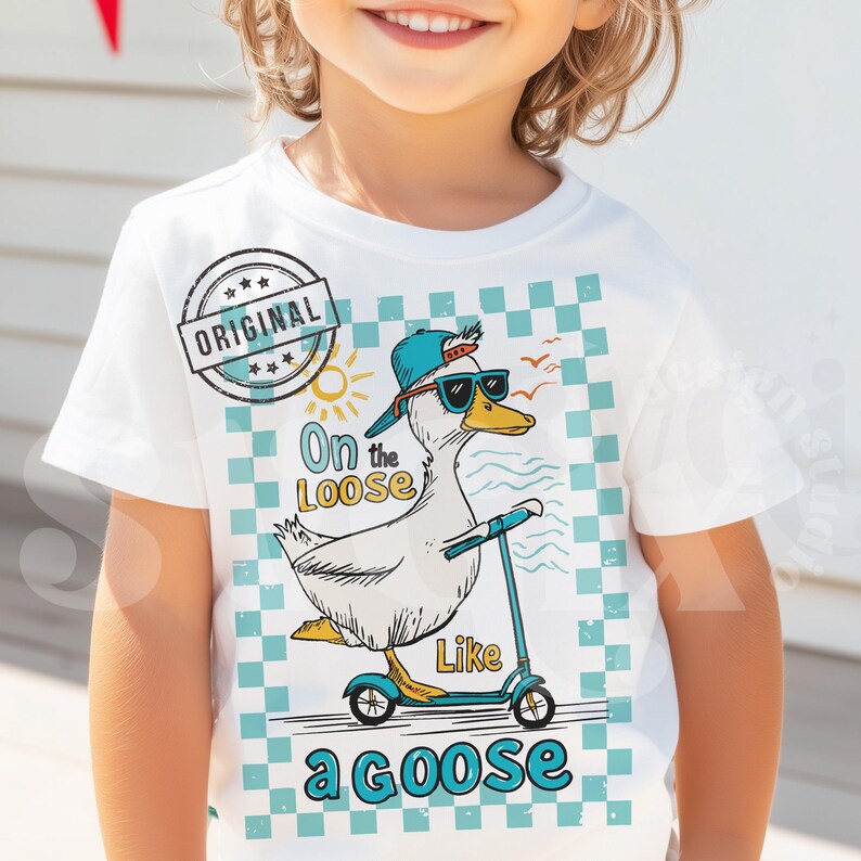 Pu&ograve; includere: Maglietta bianca con un motivo a scacchi blu e bianchi. Un'oca di cartone animato con occhiali da sole e un cappello blu sta guidando uno scooter. Il testo "On the Loose Like a Goose" &egrave; stampato sulla maglietta.
