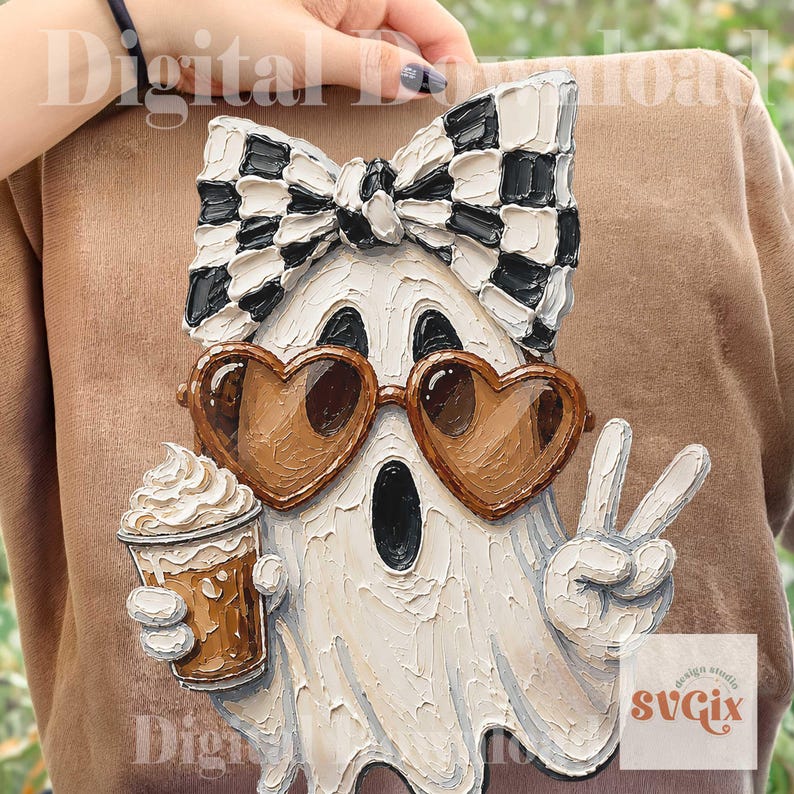 May include: A textured graphic print on a tan shirt featuring a white ghost wearing a black and white checkered bow, brown heart-shaped sunglasses, and holding a coffee cup while making a peace sign. The design has a thick, impasto paint effect.