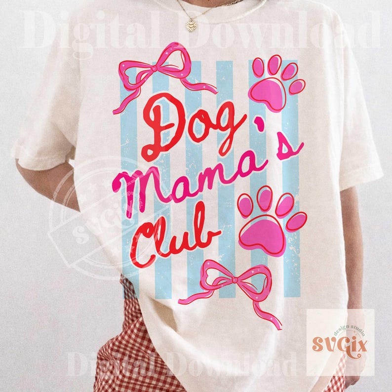 May include: Cream-colored t-shirt with the text "Dog Mama's Club" in red and pink script. The design includes pink paw prints, bows, and blue vertical stripes. A casual, pet-themed graphic tee.