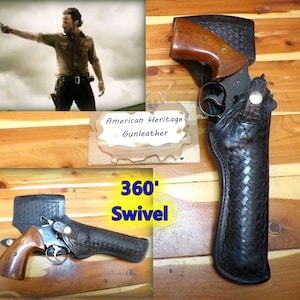 May include: A black leather holster with a basket-weave pattern and a 360-degree swivel mechanism, containing a revolver with a brown wooden grip. A sign reads American Heritage Gunleather and 360' Swivel, with an inset image of a person holding a gun.