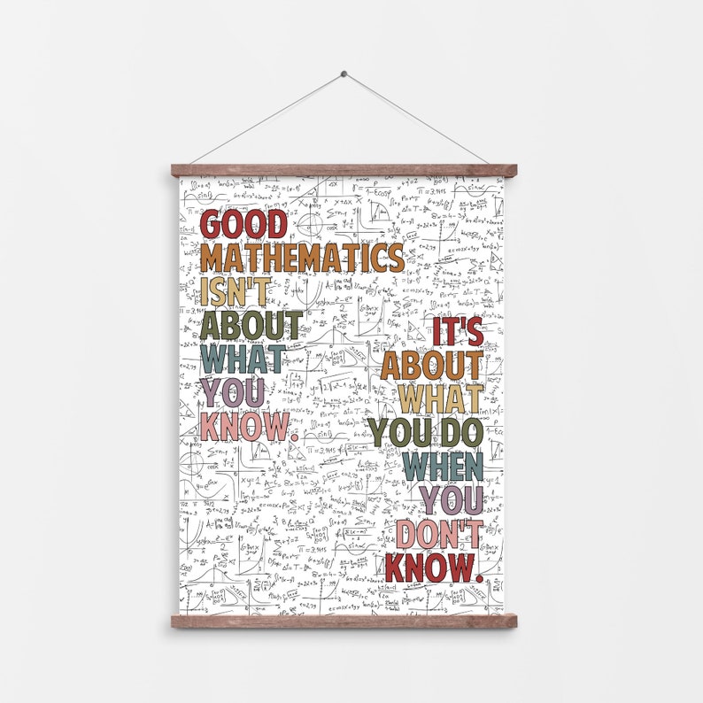 May include: A white poster with a wooden frame and a quote about mathematics. The text reads "Good Mathematics Isn't About What You Know. It's About What You Do When You Don't Know." The text is in various colors.