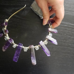 May include: A gold headband with purple and clear crystal points wrapped in silver wire.
