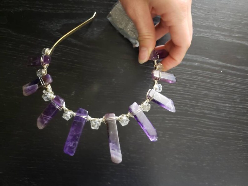May include: A gold headband with purple and clear crystal points wrapped in silver wire.