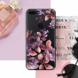 May include: A black iPhone case with a floral design featuring pink, purple, and brown roses and leaves. The case has a clear background and the floral design is printed on the back of the case.