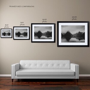 May include: Framed size comparison of four black framed photos of a mountain range reflected in a body of water. The photos are 8x10, 11x14, 16x20, and 20x30 inches.