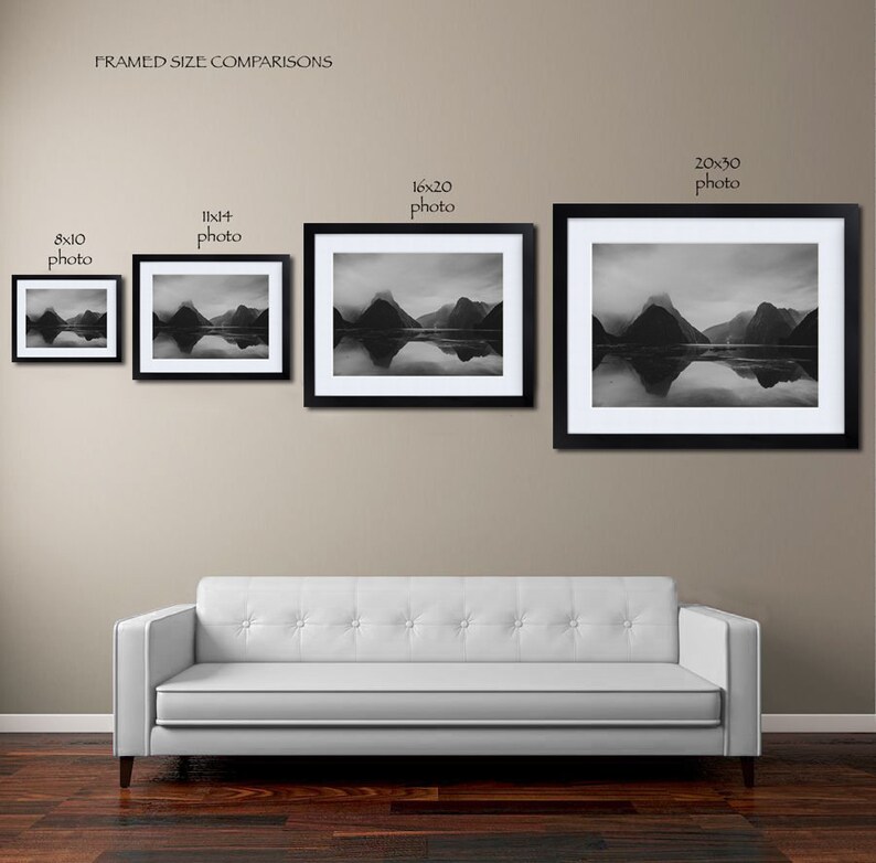 May include: Framed size comparison of four black framed photos of a mountain range reflected in a body of water. The photos are 8x10, 11x14, 16x20, and 20x30 inches.