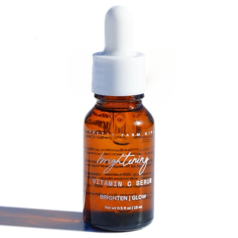 May include: A brown glass bottle with a white dropper top. The bottle is labeled "brightening vitamin c serum" and "brighten | glow". The bottle contains 0.5 fl oz / 15 ml of serum.