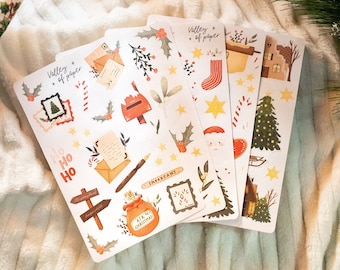 May include: Four sheets of Christmas themed stickers with illustrations of a mailbox, a Christmas tree, a stocking, a house, a sled, a candy cane, a star, a letter, a pen, a bag with the words "Air Christmas!" and the words "Valley of Paper".