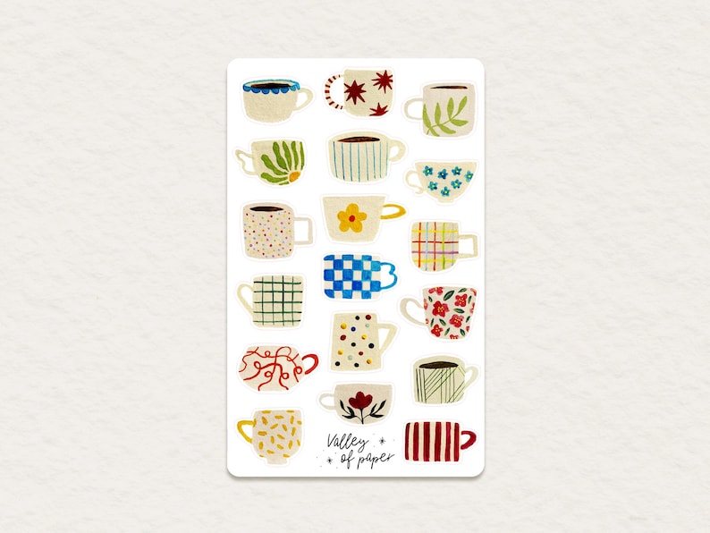 May include: A sheet of stickers featuring 18 different illustrated mugs with various patterns and colors. The stickers are labeled "Valley of Paper".
