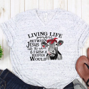 Living life between Jesus take the wheel and I wish a Heifer would T-Shirt, Women&#39;s shirt, Funny cow graphic tee