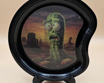 Bandeja pequeña de metal con una colorida obra de arte lenticular en movimiento.