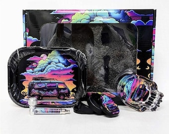 May include: A black rolling tray set with a colorful van graphic, a glass skull, and a pipe. The set includes a box with a matching design, two black containers, and a pipe. The van graphic features a sunset and clouds.